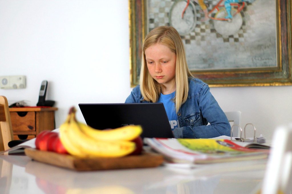 girl with laptop doing schoolwork