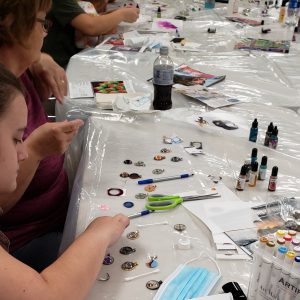 participants assembling cabochon charms