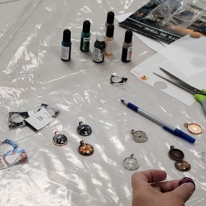 cabochon charms, charm backs, ink bottles and scraps of paper