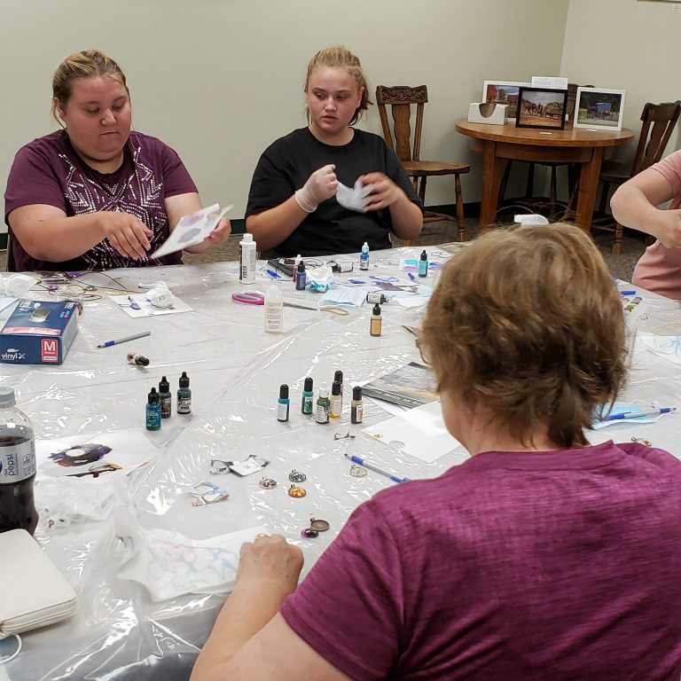 participants work on their cabochon jewelry