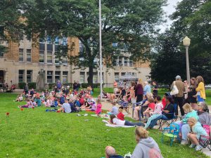 photo of large crowd on school lawn