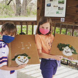 Boy and girl with clay & natural element self portraits