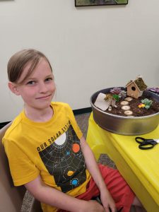 tween with fairy garden in round container