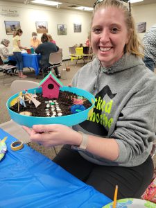 woman with fairy garden in round container