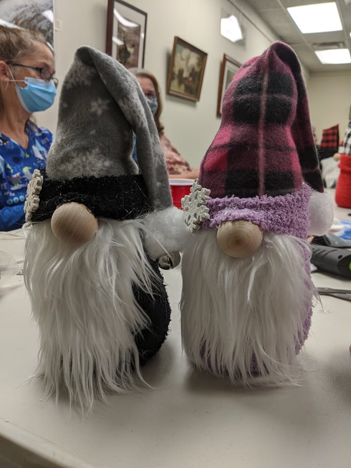 one gnome with snowflake hat, one gnome with red plaid hat.