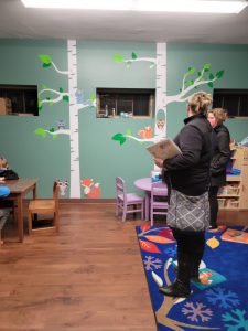 Board member Sara Talbot talks with a patron in the children's room.