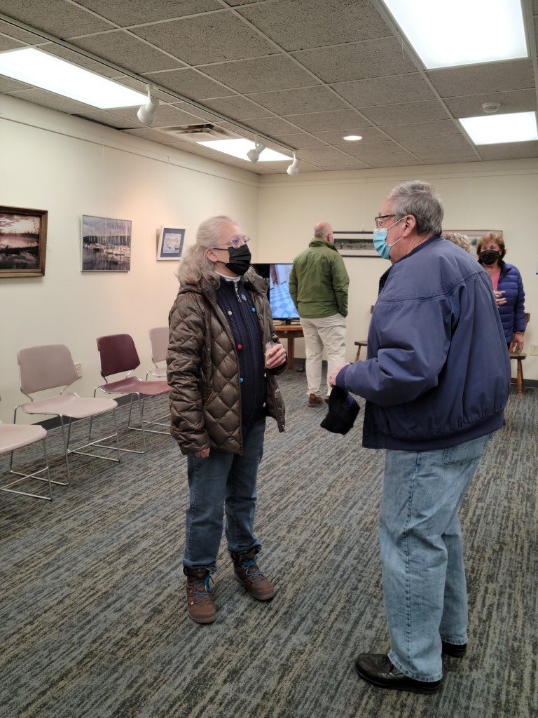 Board member Sharry Semans talks with former board member Fred Pearce at the open house.