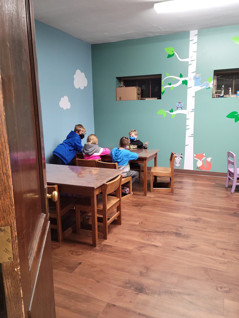 Children do crafts in the newly renovated children's area at the open house.