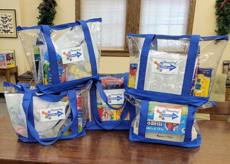 Five Penworthy STEAM to Go Phonics kits in clear zippered tote bags with blue trim
