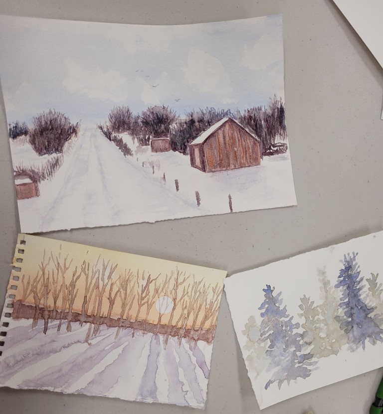 three watercolor paintings, one of a winter scene with a red barn, one of a copse of bare trees, and one of pine trees