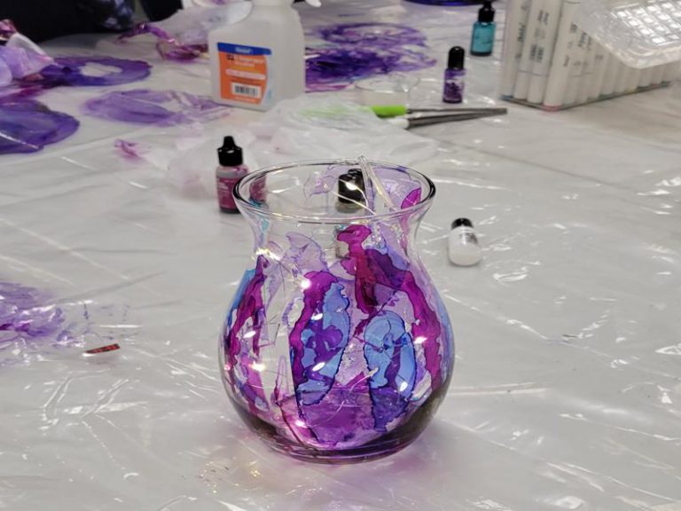 glass vase decorated with pink and purple inks with LED lights