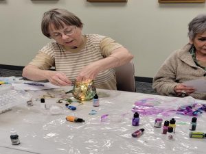 Woman adds LED lights to her finished glass jar