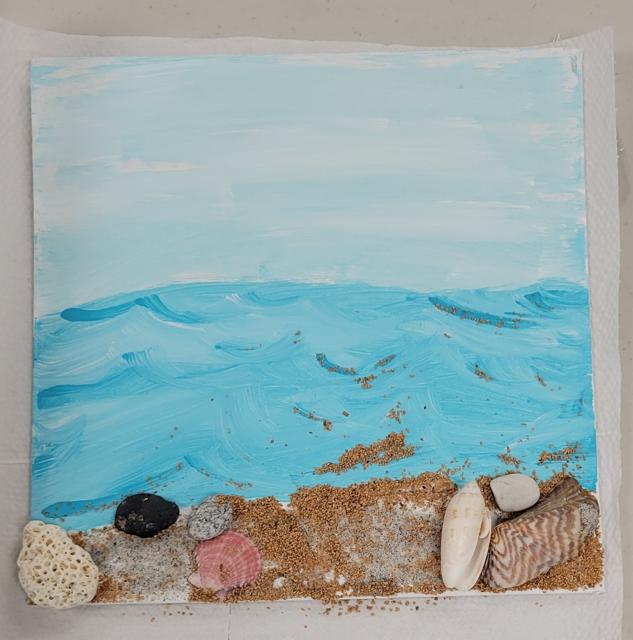 an ocean scene with a mix of sand and crushed walnut shell for the beach and pebble, shell and coral embellishments