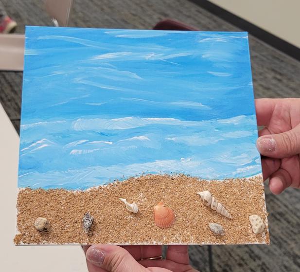 an ocean scene with a crushed walnut shell beach and seashell embellishments