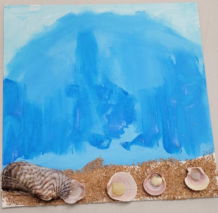 a canvas with an abstract blue ocean wave, a crushed walnut shell beach, and shells with stone 'pearls'