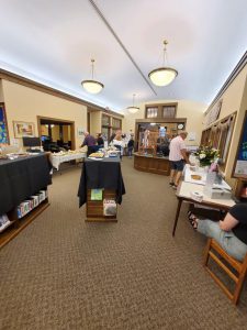 bookshelves draped in black cloths with hors d'oeuvres on top in large open library