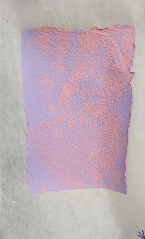 handmade paper in mixed splotches of purple and pink
