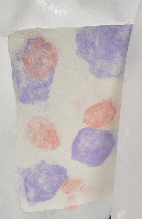 cream colored handmade paper with pink and purple spots