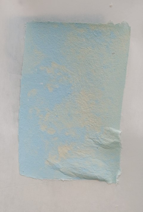 handmade paper in a splotchy blue, light green and cream