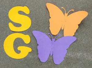yellow letters and blue and orange paper butterflies