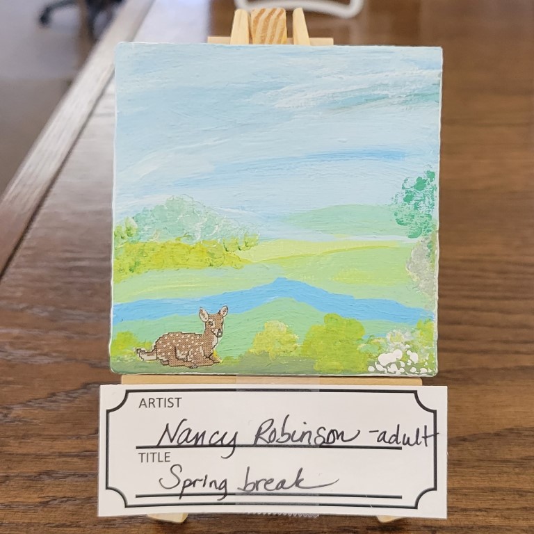 painting with blue sky, green hills, bright green bushes and a sticker of a fawn