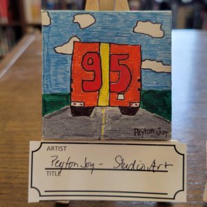 Orange Semi Truck with Yellow Vertical Center Stripe and 95 in red lettering on grey road with green grass and blue sky with white clouds