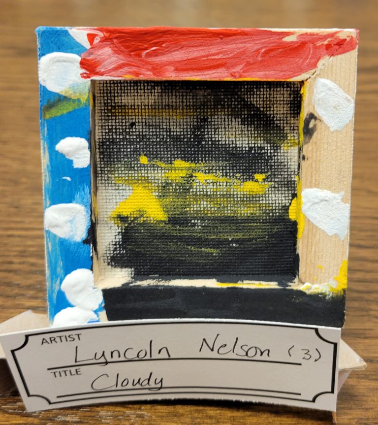 painting on back side of framed canvas with black and yellow center, and blue with white dots on left wood frame, red on top wood frame, white dots on bare wood frame on right, and black on bottom wood frame