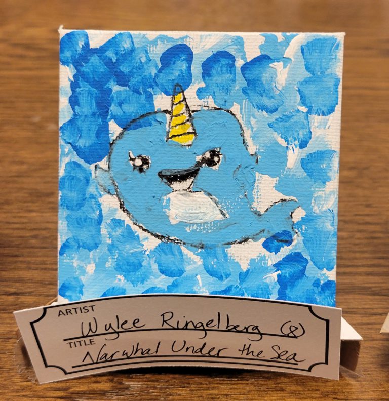 painting of a light blue cartoon narwhal with a yellow horn and a background of white with splotches of various shades of blue
