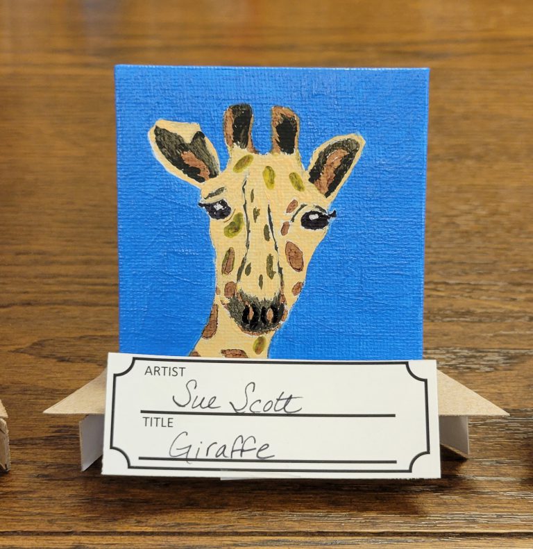 blue painting with tan and brown giraffe
