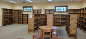 empty wooden shelves in the J and YA section