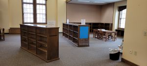 empty wooden shelves in the picture book section