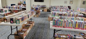 books on tables and in boxes underneath