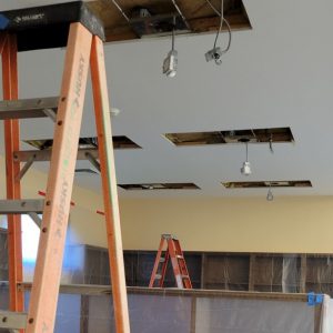 large rectangular holes in ceiling with wiring and fixtures dangling