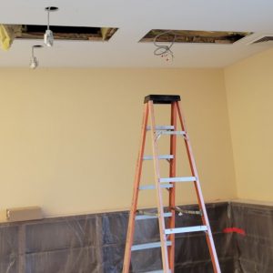 ceiling with rectangular holes with wiring and LED light fixtures dangling down