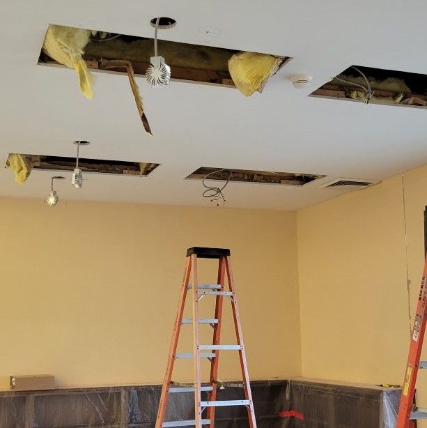 holes in ceiling with wiring and LED fixtures dangling