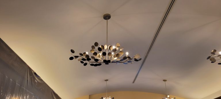 metal pendant light with leaf and branch shaped design