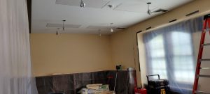 ceiling with drywall patches and light fixtures dangling