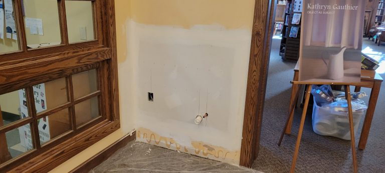 wall with additional drywall compound and tape on patch seams
