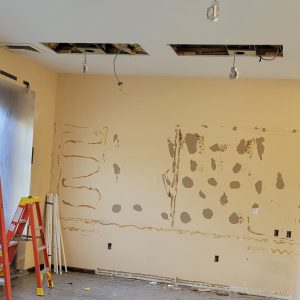 wall with glue and patches of paint removed