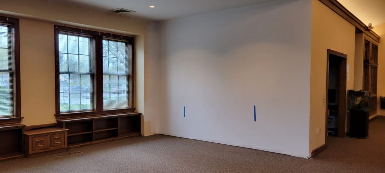 children's area and computer lab shared wall painted white with baseboard removed
