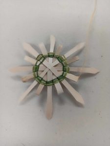 star or snowflake shaped ornaments woven with green sweetgrass and black ash splint