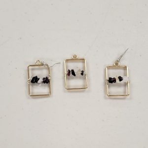 gold rectangular bezels with black, purple, and clear quartz crystal chips strung on wire across the center