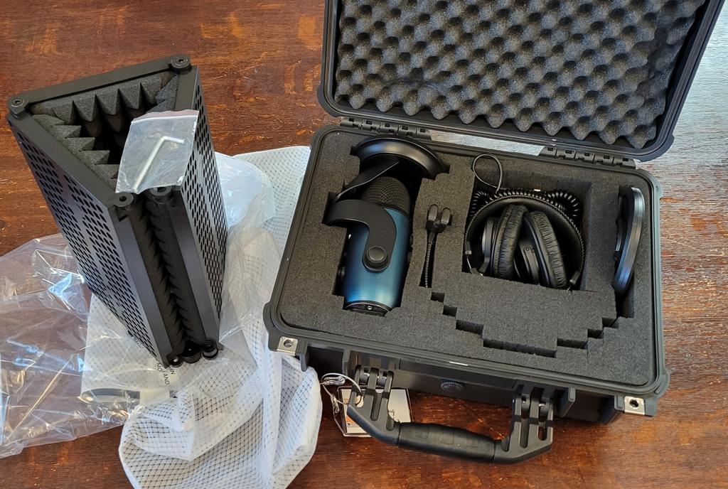 black plastic case with handle and foam with podcasting equipment