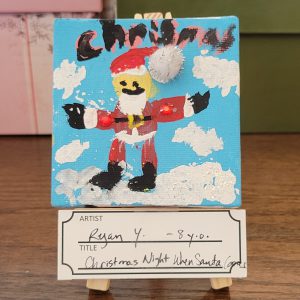 blue background with child's painting of Santa with pompom glued on and "chrismas"