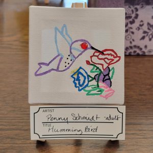 hummingbird with red, blue, and purple flowers