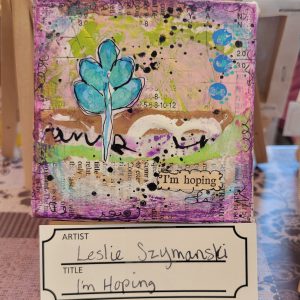 decoupaged paper with green and purple paint accents, blue and black dots, and a blue plant with words "I'm hoping"