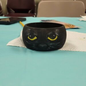 black bangle with yellow eyes and cat face