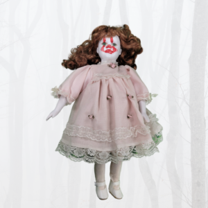 doll with pink dress and red hair with Pennywise the clown makeup