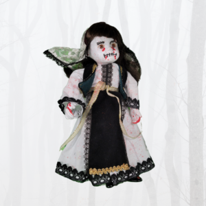 porcelain doll with bloody dress and face painted with blood and mouth stitched closed