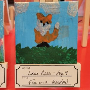 A colorful painting of an orange and white fox in a meadow with a blue sky and clouds.